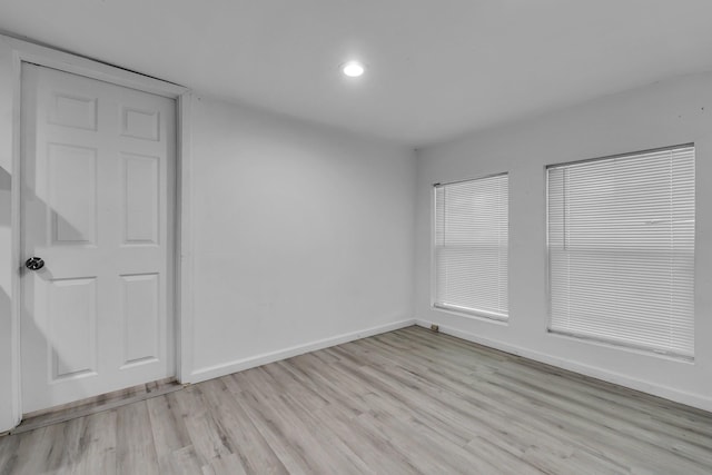 spare room with light hardwood / wood-style flooring