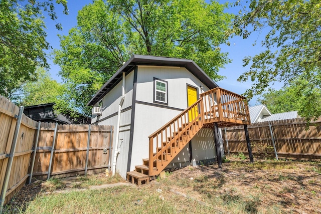 rear view of property featuring a wooden deck