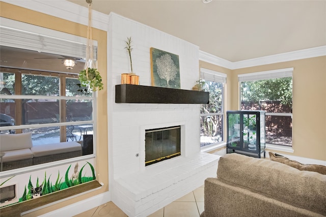 living room with a fireplace, ornamental molding, and light tile patterned floors