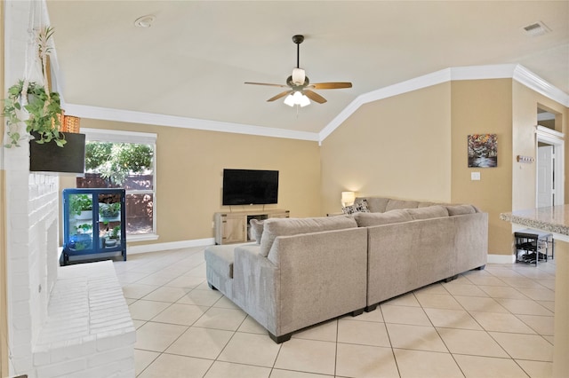 living room with light tile patterned floors, a fireplace, vaulted ceiling, ceiling fan, and crown molding