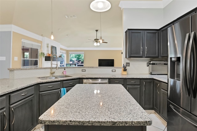 kitchen featuring ceiling fan, backsplash, sink, light tile patterned flooring, and stainless steel appliances