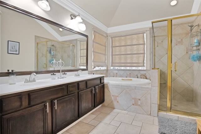 bathroom featuring a healthy amount of sunlight, dual vanity, tile patterned flooring, vaulted ceiling, and shower with separate bathtub