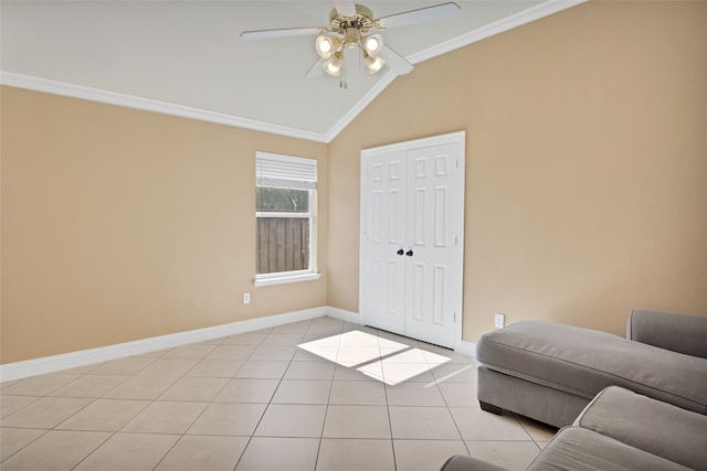 interior space featuring ceiling fan, light tile patterned floors, ornamental molding, and lofted ceiling