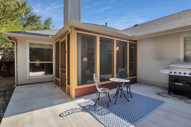 view of patio / terrace featuring a grill and a sunroom