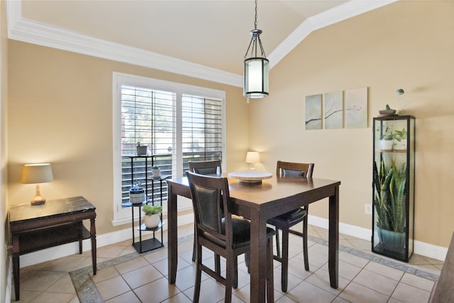 tiled dining area with vaulted ceiling and ornamental molding