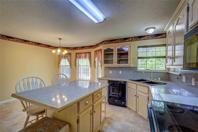 kitchen with light tile patterned floors, black dishwasher, decorative backsplash, and a healthy amount of sunlight