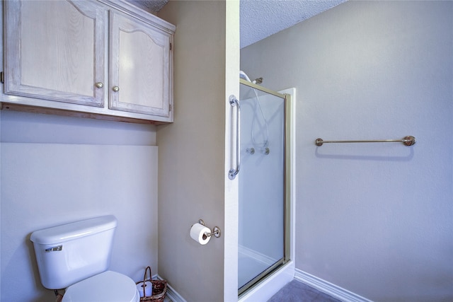 bathroom with tile patterned flooring, a textured ceiling, walk in shower, and toilet