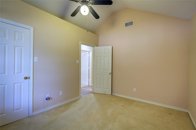 unfurnished bedroom with ceiling fan, light colored carpet, and lofted ceiling