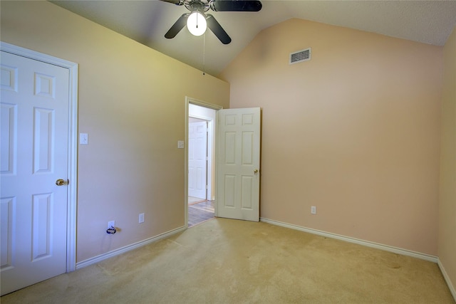 unfurnished bedroom featuring light carpet, visible vents, baseboards, ceiling fan, and high vaulted ceiling