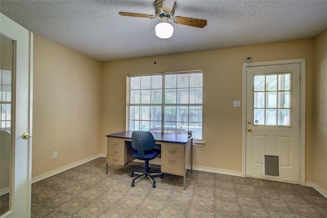 home office featuring ceiling fan, baseboards, and a textured ceiling