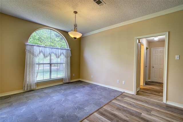 spare room with a textured ceiling, hardwood / wood-style floors, and ornamental molding