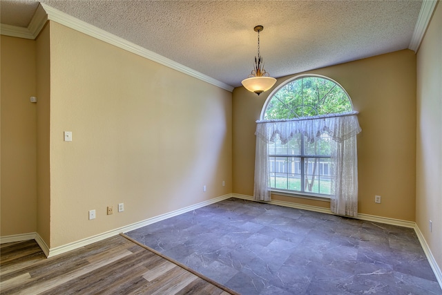 spare room featuring wood-type flooring, ornamental molding, and a textured ceiling