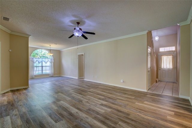 unfurnished room featuring ceiling fan, a textured ceiling, crown molding, and wood-type flooring