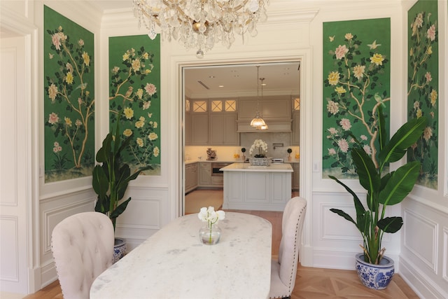 dining space with crown molding, light parquet flooring, and an inviting chandelier