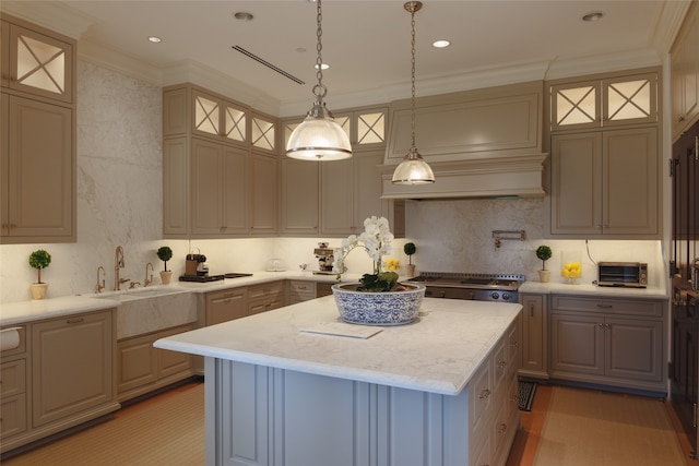 kitchen featuring hardwood / wood-style flooring, a kitchen island, range, sink, and decorative light fixtures