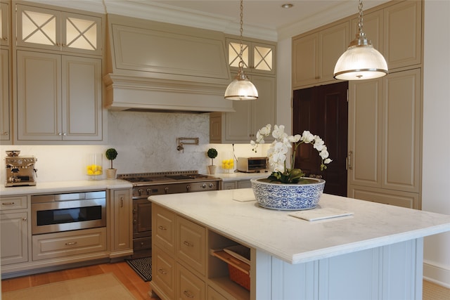 kitchen with a center island, light hardwood / wood-style floors, decorative backsplash, and decorative light fixtures