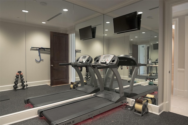 workout area with ornamental molding and recessed lighting