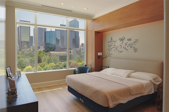 bedroom featuring crown molding and wood-type flooring