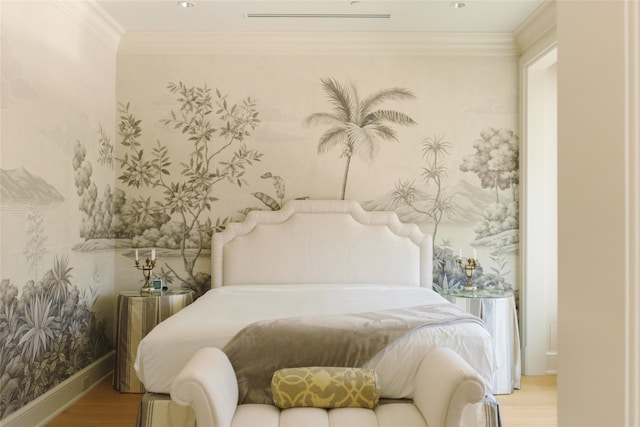 bedroom with light wood-type flooring and ornamental molding