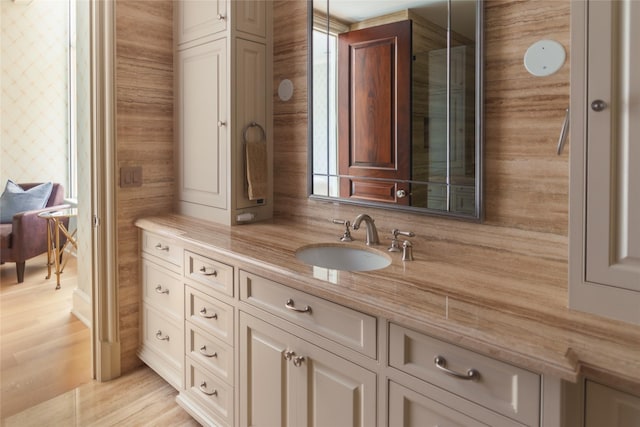 bathroom with wood finished floors and vanity