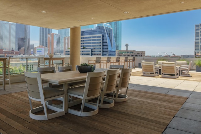 exterior space with expansive windows, wood-type flooring, and a city view