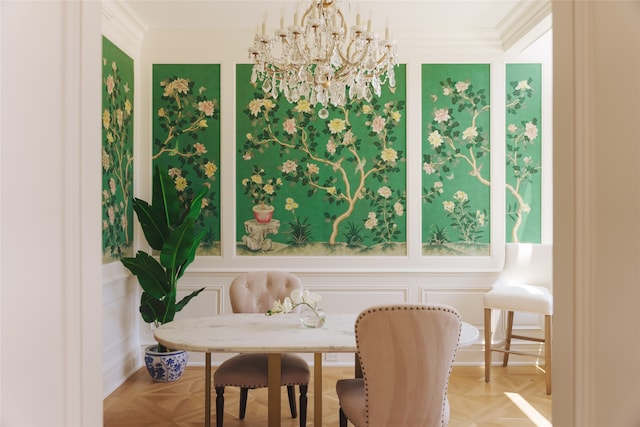 dining area with crown molding, light parquet flooring, and a chandelier