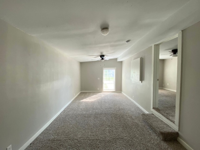 unfurnished room with ceiling fan and carpet floors