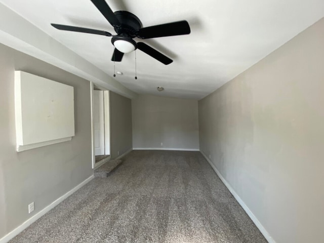 unfurnished room with ceiling fan and carpet