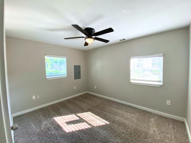 empty room featuring carpet, electric panel, and ceiling fan