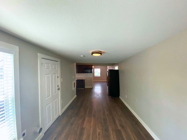 hallway with dark hardwood / wood-style floors