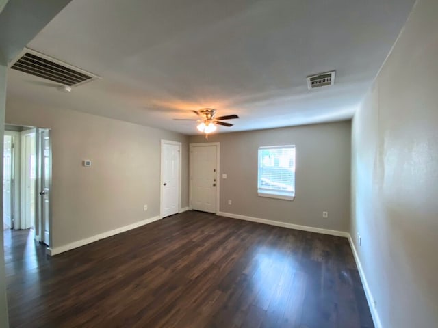 spare room with ceiling fan and dark hardwood / wood-style floors