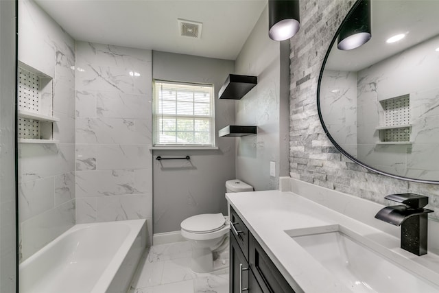 full bathroom featuring toilet, vanity, tile patterned floors, tile walls, and tiled shower / bath