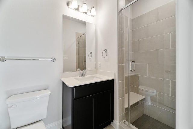 bathroom with vanity, toilet, and walk in shower