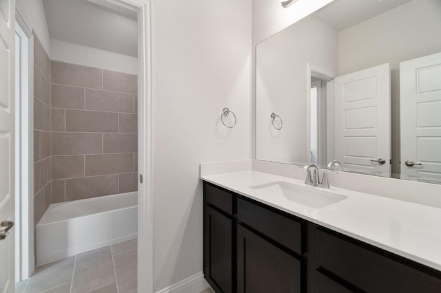 bathroom with tile patterned flooring, vanity, and tiled shower / bath