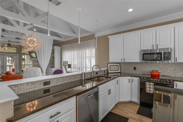 kitchen with sink, light wood-type flooring, appliances with stainless steel finishes, decorative backsplash, and white cabinetry