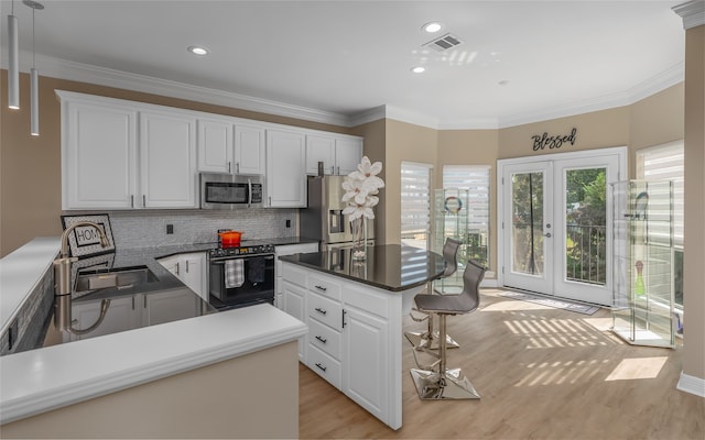 kitchen featuring stainless steel appliances, light hardwood / wood-style floors, decorative backsplash, white cabinetry, and crown molding