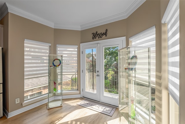 interior space with crown molding, light hardwood / wood-style flooring, and french doors