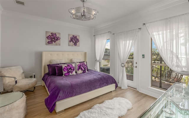 bedroom with light hardwood / wood-style floors, crown molding, and access to outside