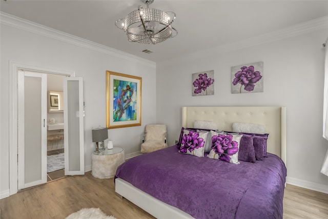 bedroom with crown molding, light hardwood / wood-style flooring, and a chandelier