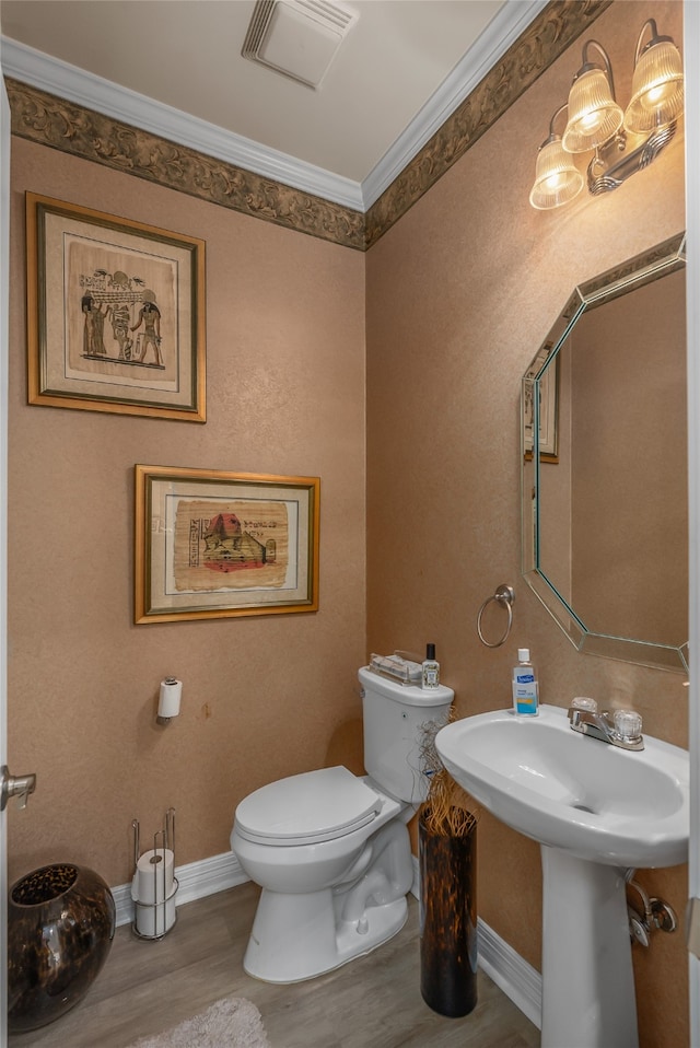 bathroom featuring crown molding, wood-type flooring, and toilet