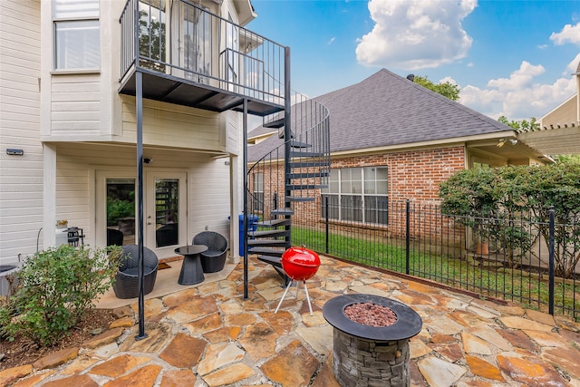 view of patio / terrace with a balcony and a fire pit