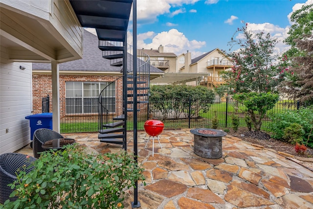 view of patio with a pergola and a fire pit