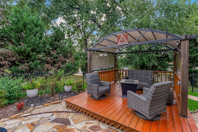 wooden terrace featuring a gazebo and an outdoor living space