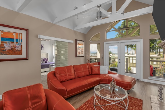 living room with ceiling fan, high vaulted ceiling, hardwood / wood-style floors, french doors, and beamed ceiling