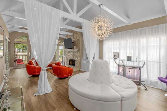 interior space featuring light hardwood / wood-style floors, a chandelier, and a stone fireplace