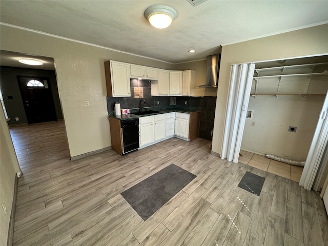 kitchen featuring light hardwood / wood-style floors, white cabinetry, tasteful backsplash, sink, and wall chimney range hood