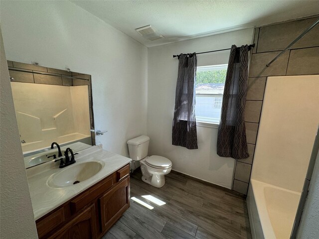 full bathroom featuring vanity, shower / tub combo with curtain, and toilet