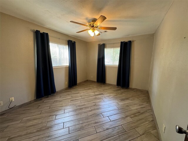 spare room with ceiling fan