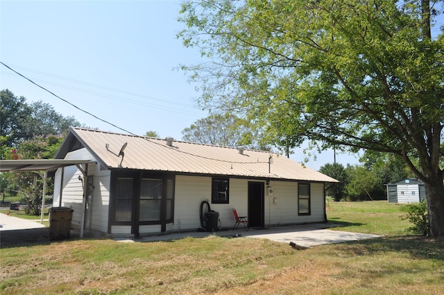 rear view of house with a yard