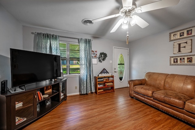 living room featuring ceiling fan and wood-type flooring